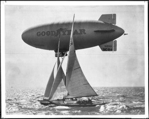 Goodyear Blimp flying beside two sailing yachts, ca.1929