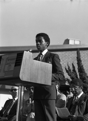Young man speaking at a lectern, Inglewood, California, 1985