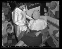 Los Angeles Coiffure Guild woman wearing electric face mask, circa 1939