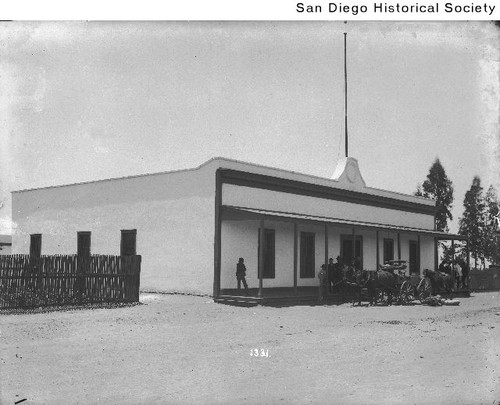 People standing on the porch of a Baja California Customs house