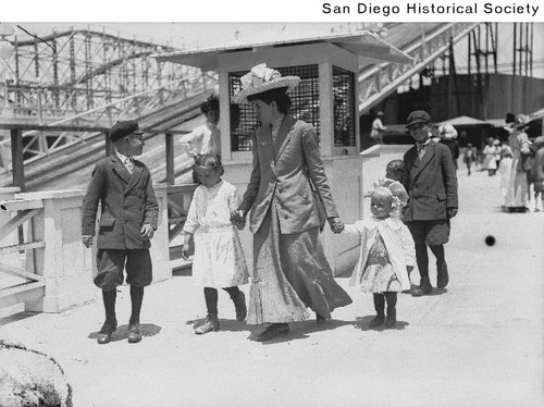 A women with her children walking by the waterslide at Ocean Beach's Wonderland Amusement Park