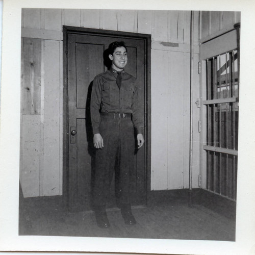 Servicemen standing in front of door at Camp Drake