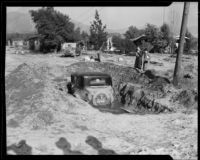 Automobile covered in mud left by January flood waters, La Crescenta-Montrose, 1934