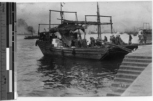 Barge being loaded in Hong Kong harbor, China, ca.1920