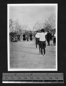 Ginling College student participating in archery, Nanjing, Jiangsu, China, 1932