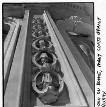 View of the cast iron decorations on the California State Capitol dome before being sandblasted and painted during the restoration project. Decorations show many coats of paint and rust