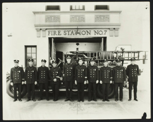 Uniformed firefighters line up in front of Station No. 7, Hill & Linden