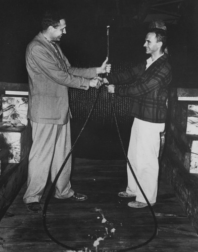 Roger Revelle and Jeffery Frautschy hold wire cable delivered to R/V Spencer F. Baird, on the eve of the departure of the Capricorn Expedition