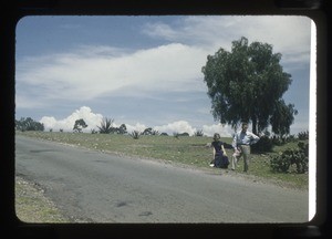 Man and woman by side of a road