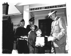 Man handing leaflets to Boy Scouts, Petaluma, California, about 1956