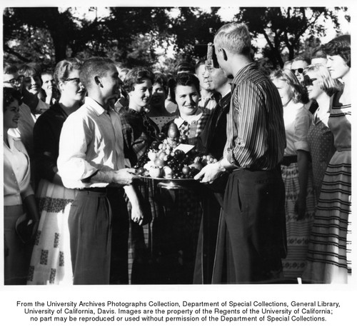 Inaugural ceremonies for University of California President Clark Kerr at the Davis campus, Students present fruit to Kerr