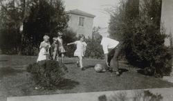 Wheeler and Cochrane children playing ball with Herbert Cochrane in an unidentified yard, Petaluma, California, Thanksgiving Day, 1929