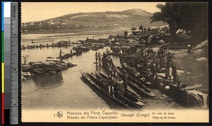 Boats loaded with cargo on the shore of the Ubangi, Congo, ca.1900-1930