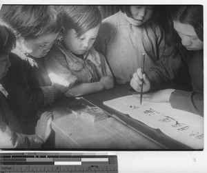 Learning to write at Fushun, China, 1937