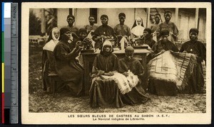Indigenous novices pose with sewing machines, Libreville, Gabon, ca. 1900-1930