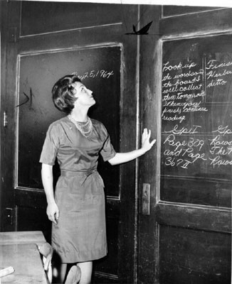 [Burnett School teacher Lois Vonzell showing thin folding door separating her class from adjoining one]