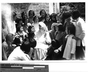 A Maryknoll Sister telling children a story at Lipu, China