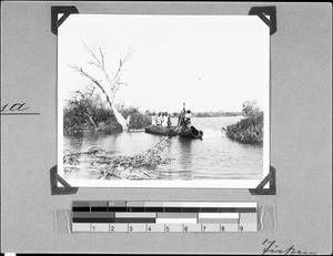 People sitting in a boat on the Mbasi River, Nyasa, Tanzania, 1936