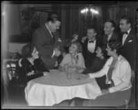 David L. Hutton, estranged husband of Aimee Semple McPherson, sings to a table of women in a nightclub, Los Angeles, 1933