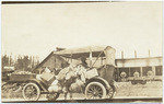 [Loaded car in front of Colfax roundhouse]