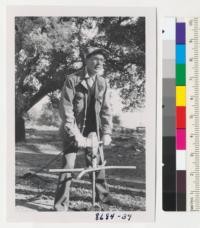 H.A. Nielsen of Santa Cruz demonstrates electric power post hole digger he has used in preparing holes for trees. Metcalf. Dec. 1952