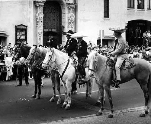 Four horsemen in front of Methodist Church