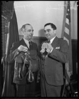 Mexican consul Joaquin Terrazas and Los Angeles County Sheriff Eugene Biscailuz with saddle and spurs, [1935?]