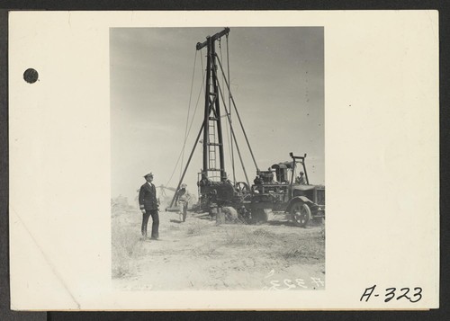 Parker, Ariz.--Lieutenant Commander Ralph B. Snavely of the U.S. Public Health Service watches well-digger bore for fresh water at War Relocation Authority center for evacuees of Japanese ancestry on Colorado River Indian Reservation. Photographer: Albers, Clem Parker, Arizona