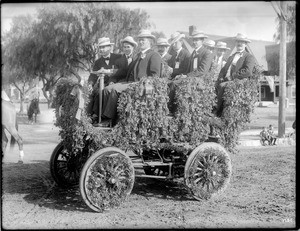 Group of men seated in a decorated automobile for the Pasadena Tournament of Roses parade, ca.1903