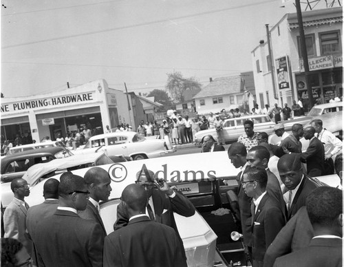 Pallbearers loading the casket of Ronald Stokes into a hearse, 1962