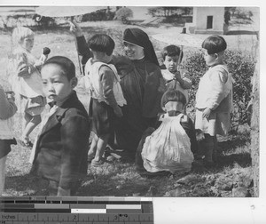 Sister M. Eva playing with children at Fushun, China, 1935