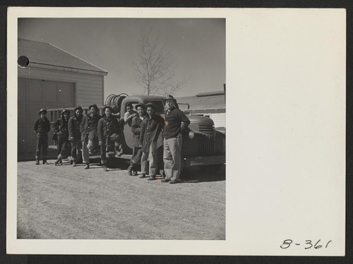 Evacuee firemen are shown posed beside their fire truck. Excellent work by this trained crew has minimized fire and fire damage in this War Relocation Authority Center for evacuees of Japanese descent. Photographer: Stewart, Francis Topaz, Utah