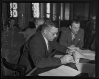 Robert F. Witter and Lewis E. Arnold, city employees at work in the council chamber, Los Angeles, 1935