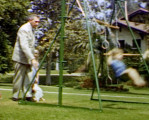 Silent 8 mm film (C) of George Pepperdine playing with children in the yard of their home