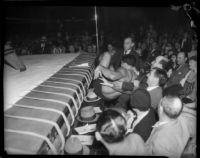 Wrestler lands in crowd during Dusek-López wrestling match, Los Angeles, 1935