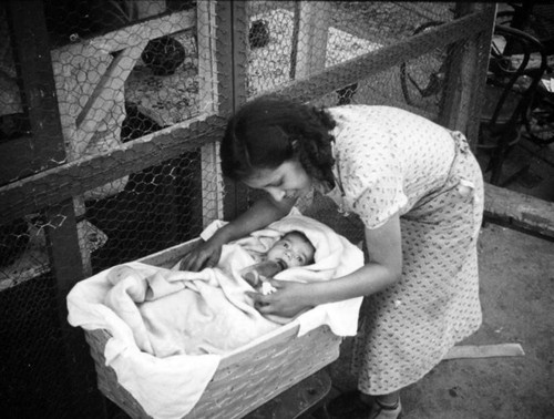 Mother with baby in bassinet, Olvera Street