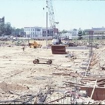 Site of the Downtown Plaza Parking Garage, Lot "G" near Macy's Department Store, 4th, 5th K and L Streets under construction. This view is looking east from the Fratt Building in Old Sacramento