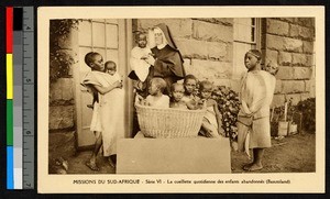 Missionary sister holding young child among other young children, South Africa, ca.1920-1940