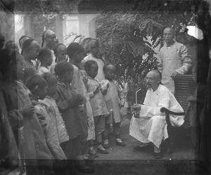Fr. Vincent Lebbe talking to a group of Chinese children, China, ca. 1906-1919