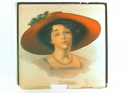 Stock label: woman wearing red sun hat with green bow, pink dress and necklace
