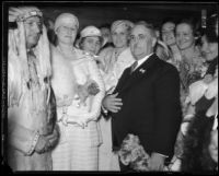 Los Angeles Mayor Frank Shaw, Mrs. Cora Shaw, group of women, and man in Indian dress, 1933-1938