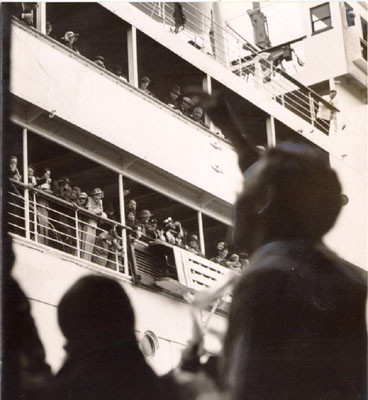 [People standing at the rails of a cruise ship]