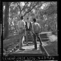 Juvenile offenders counselor talking with pair of boys at youth rehabilitation Camp Malibu, Calif., 1964