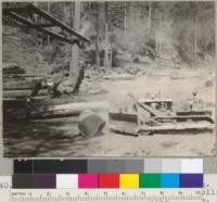 Redwood Region. Peeling at the landing. Casper Lumber Company, Camp 20. Tractor rolling peeled log within reach of loading boom. 8/20/40. E.F