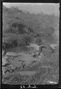 African child at the river, Antioka, Mozambique, ca. 1916-1930