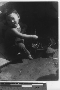 A baby playing at Fushun, China, 1937