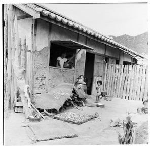 Man looking out window of his house, young girl outside, Korea