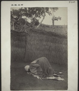 Hausa priest in Winnebah, touching the ground with his forehead in prayer