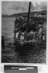 Unloading a junk, Hong Kong, China, ca. 1930