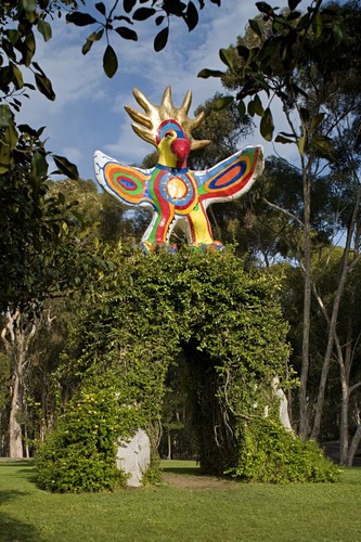 Sun God: front view with sculpture supported by vine-covered, concrete arch